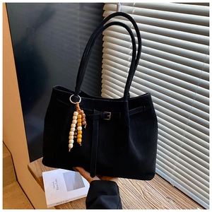 Detail der schwarzen Wildledertasche mit Zierschnalle und böhmischem Perlenanhänger