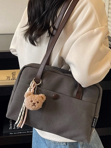 Grey canvas tote bag with brown leather straps and cute plush bear charm for women
