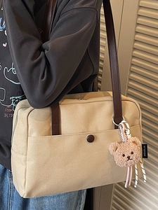 Minimalist apricot canvas tote bag with brown leather straps and cute bear charm
