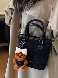 Retro black bucket bag for women with cute plush bear pendant and golden hardware details