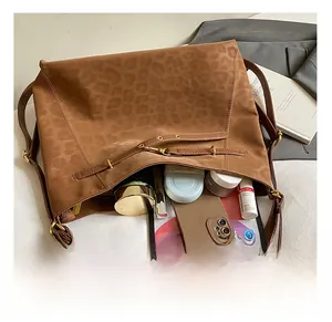 Spacious leopard print tote bag interior showing capacity for tablets and cosmetics