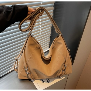 Detailed view of the soft suede leather texture and metallic D-ring buckle on the tote bag