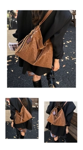 Detailed macro view of large leopard print tote bag with purple bear charm and fringe