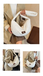 Detailed close-up of a white quilted crossbody bag with heart pattern and leather patch