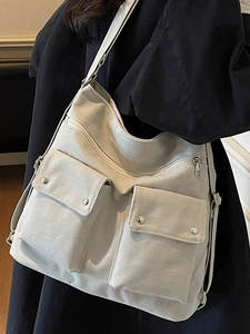 Minimalist large capacity crossbody shoulder bag with multi-pocket design in cream canvas