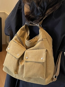 Large mustard yellow canvas tote bag with functional front pockets and shoulder straps