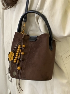 Retro dark brown matte suede bucket bag with stylish ethnic tassel and round handle