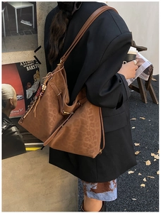 Detailed view of a retro leopard print tote bag with stylish tassels in urban street style