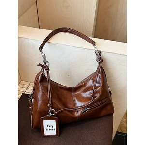 Brown vintage faux leather tote bag with silver zippers and lazy breeze hangtag detail