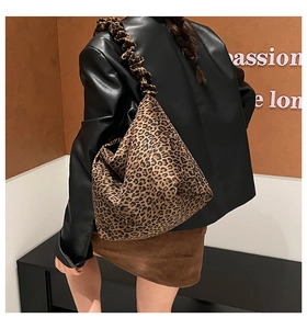 Detail of leopard print tote bag with stylish scrunchie shoulder strap and large capacity