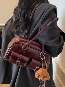 Retro burgundy Boston handbag in shiny leather with plush pendant and metal buckles