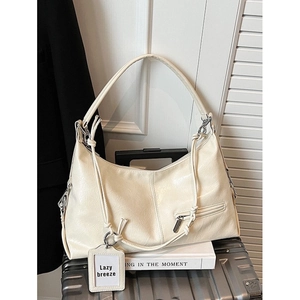 Creamy beige hobo shoulder bag in textured faux leather with silver zipper detail