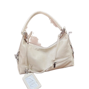 Creamy white pleated hobo bag in soft leather with spacious interior and shoulder strap
