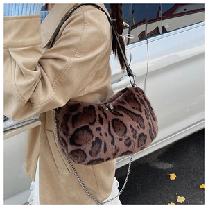 Close-up of leopard print faux fur shoulder bag with silver metal clasp and chain strap