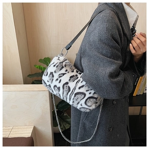 Chic leopard print plush crossbody bag with silver chain and leather strap on model