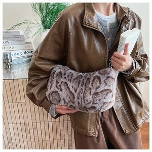 Detail view of leopard print plush bag with silver chain strap and faux fur texture