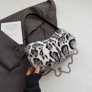 Close-up of leopard print faux fur bag with black leather strap and silver chain