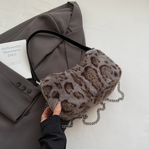 Close-up of leopard print faux fur bag with silver chain detail and leather strap