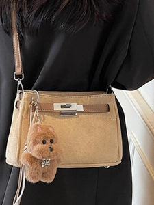 Khaki matte suede crossbody bag with silver twist lock and cute dog charm detail