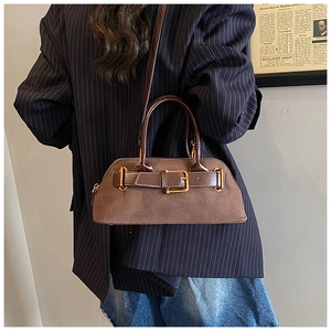 Detail of mocha brown vintage tote bag showing suede texture and gold buckle accents