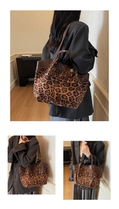 Detail view of large leopard print tote bag featuring premium leather handles and trim