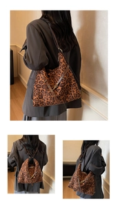 Detail view of large leopard print hobo bag with brown shoulder strap and metal buckle