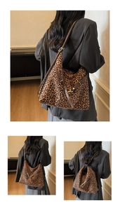 Detail of adjustable leather strap and golden buckle on leopard print bucket bag