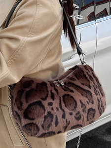 Chic leopard print faux fur shoulder bag with silver chain strap for women shown in lifestyle view