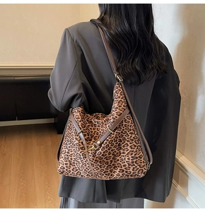 Detailed back view of a stylish leopard print bucket bag with brown leather straps