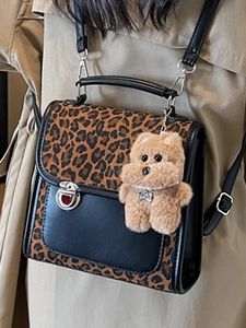 Fashionable leopard print and black leather mini backpack with plush bear charm