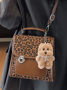 Retro leopard print handbag with structured design, metal clasp and cute puppy charm