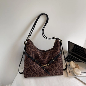 Close-up of leopard print bucket bag with black leather straps and gold hardware