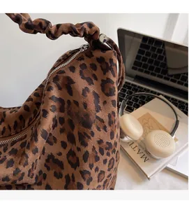Close-up of leopard print tote bag with soft suede texture and ruched cloud handle