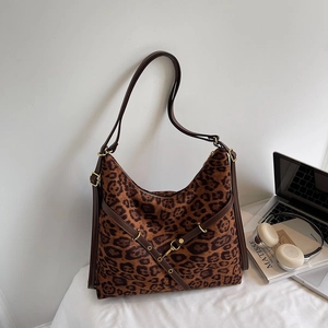 Detailed view of leopard print hobo bag with adjustable strap and golden buckles