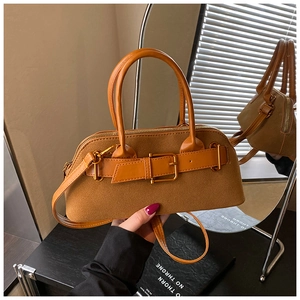 Detail of caramel brown suede tote with metal buckle and adjustable shoulder strap