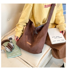 Detail of the soft brown suede hobo bag featuring leopard print lining and brand label