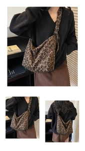 Detailed views of leopard print oversized tote bag worn by a model in a stylish setting