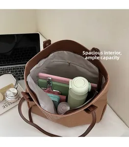 Macro view of spacious interior storage and textured croc-embossed finish of tote bag