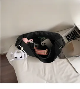 Interior view of black quilted dumpling bag with large capacity and cute crab pendant