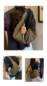 Detailed macro shot of vintage leopard print tote bag with brown plush bear charm