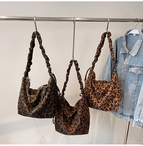 Detail of leopard print tote bags with scrunchie straps and metal zip closure