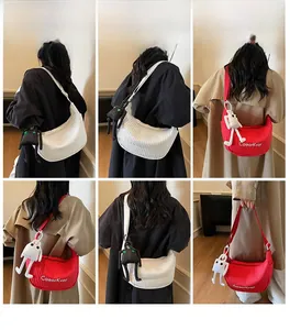 Quilted crescent crossbody bag with logo and adjustable strap shown from multiple angles