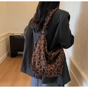 Detail view of large leopard print tote bag with stylish scrunchie shoulder strap