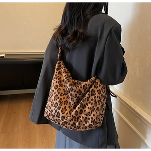 Detailed back view of a stylish leopard print oversized tote bag on a female model