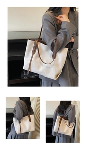Detail of white woven texture and brown leather straps on a large tote bag for women