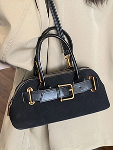 Vintage black suede handbag with gold buckle and adjustable strap for shoulder wear