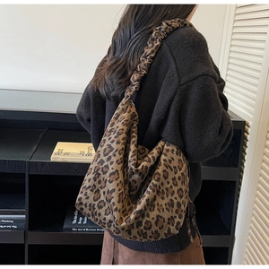 Detail of leopard print tote bag with ruched shoulder strap and soft suede texture