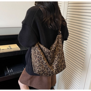 Detail of large leopard print tote bag showing texture and wide shoulder strap