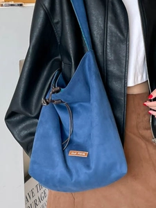Ethnic floral denim patchwork tote bag with blue suede finish and brown drawstring closure