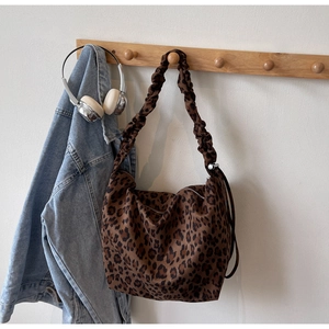 Detailed view of large leopard print tote bag with stylish ruffled shoulder strap design